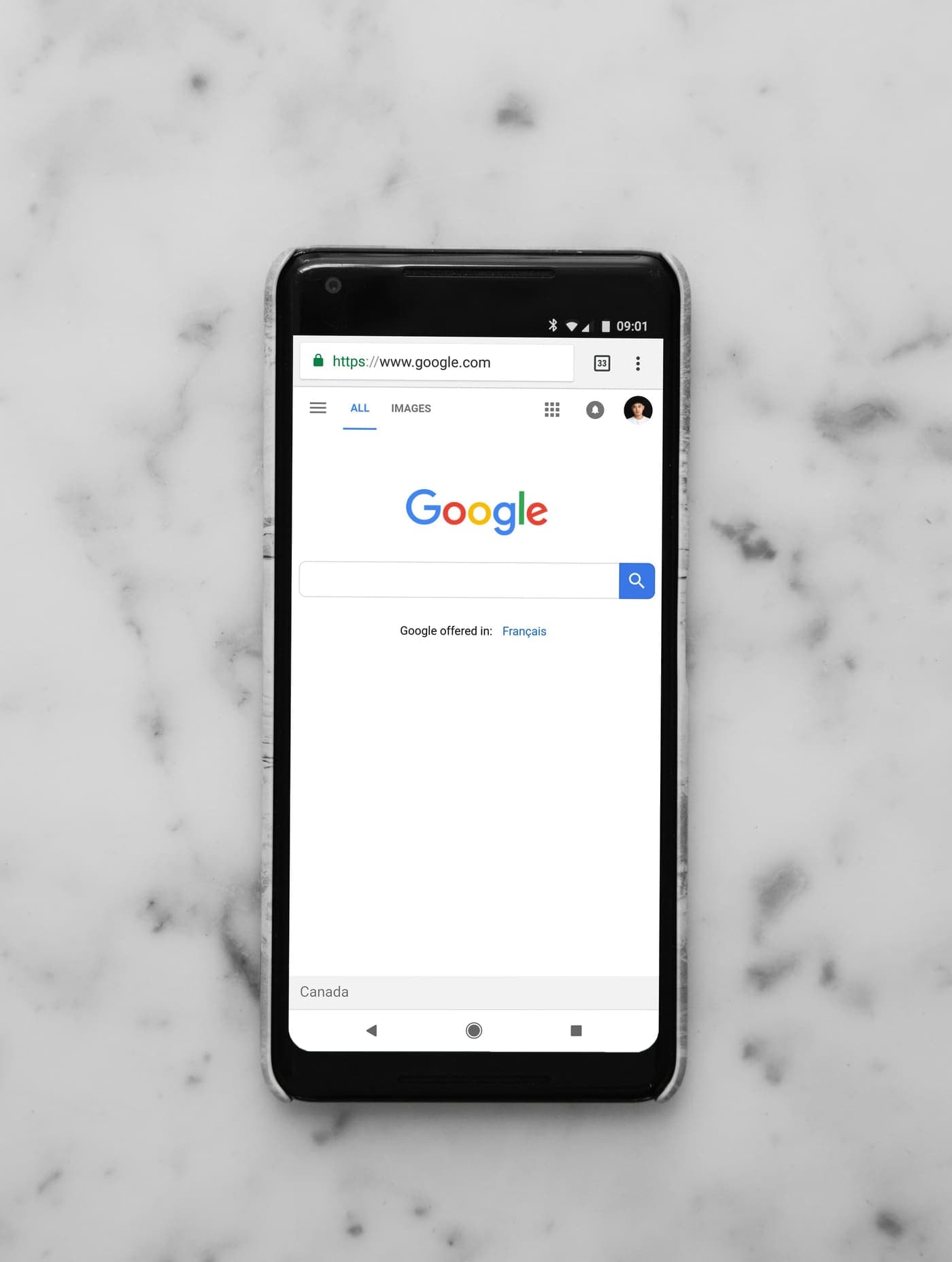 Smartphone on a marble counter showing Google search on mobile