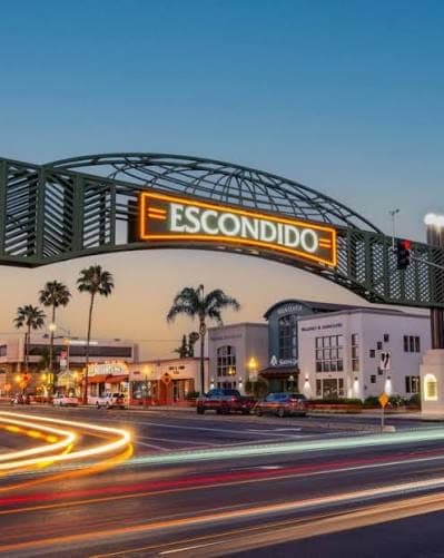 Escondido sign over Grand Avenue at dusk in downtown Escondido, California